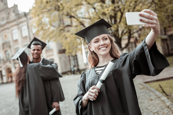 Positive delighted blonde student doing selfie photo - Photo, Image