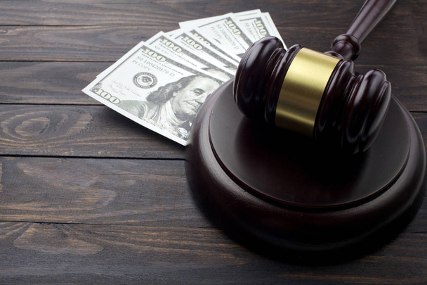 judge gavel and money on brown wooden table concept - 写真・画像