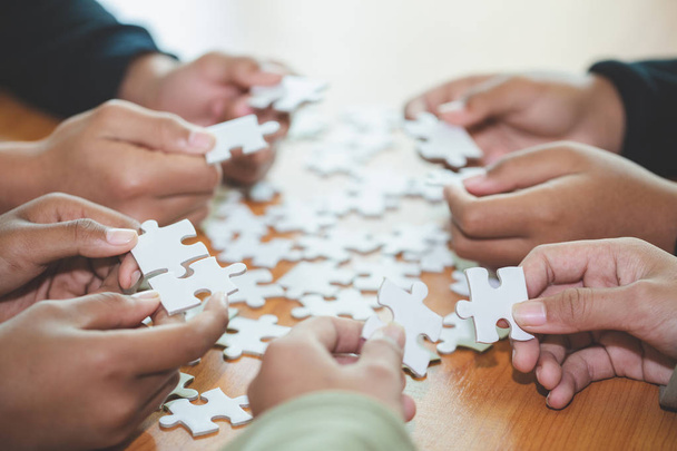 persone che aiutano a assemblare puzzle, cooperazione nel processo decisionale
 - Foto, immagini