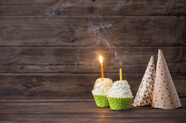birthday cupcakes with candles on old dark  wooden background - Foto, imagen