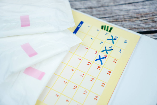 Stacked sanitary napkin pad on calendar - Photo, Image