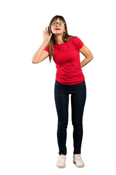 Full-length shot of Woman with glasses listening to something by putting hand on the ear - Photo, Image