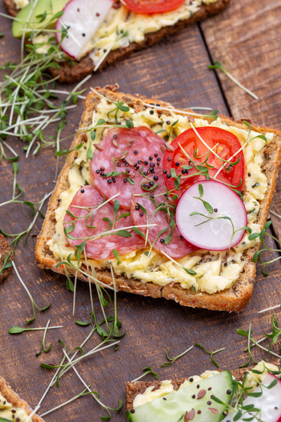 Sandwiches with cream cheese, vegetables and salami. - Φωτογραφία, εικόνα