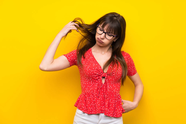 Young woman over yellow wall with tired and sick expression - Photo, image