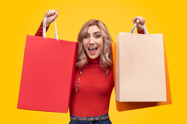 Excited woman with paper bags - Foto, imagen