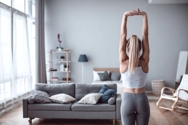 Fit woman exsercise in the room at home. - Foto, imagen