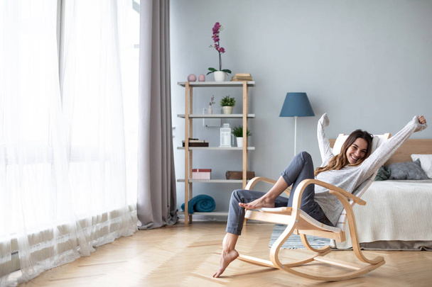 Happy young woman relaxing at home. - Foto, Bild