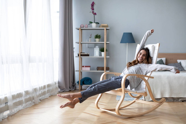 Happy young woman relaxing at home. - Valokuva, kuva