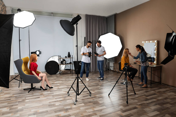Photo studio with professional equipment and team of workers - Фото, изображение