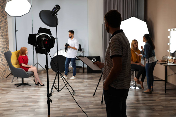 Photo studio with professional equipment and team of workers - Fotó, kép