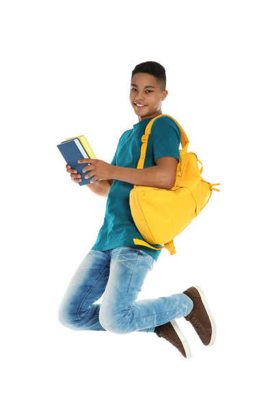 African-American teenager boy with books on white background - Foto, afbeelding