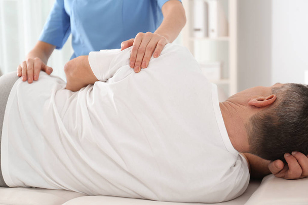 Doctor working with patient in hospital, closeup. Rehabilitation massage - Foto, Imagem
