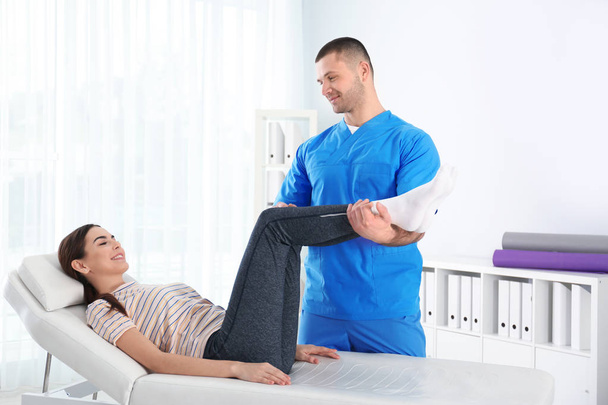 Doctor working with patient in hospital. Rehabilitation physiotherapy - Photo, image