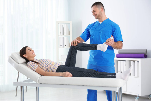 Doctor working with patient in hospital. Rehabilitation physiotherapy - Valokuva, kuva