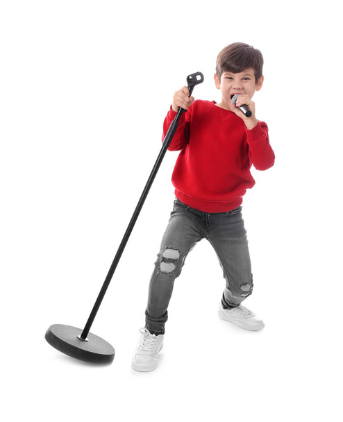 Cute little boy singing into microphone on white background - Foto, Bild