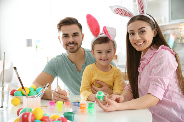 Happy family painting Easter eggs in kitchen. Festive tradition - Fotoğraf, Görsel