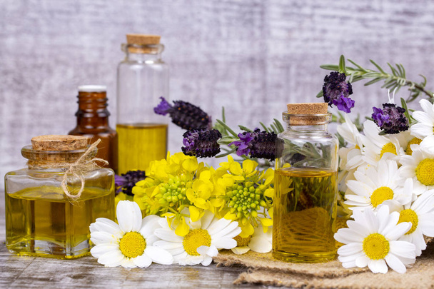 Mixed herbal oil. Essential oil various. Colorful flowers. - Foto, afbeelding
