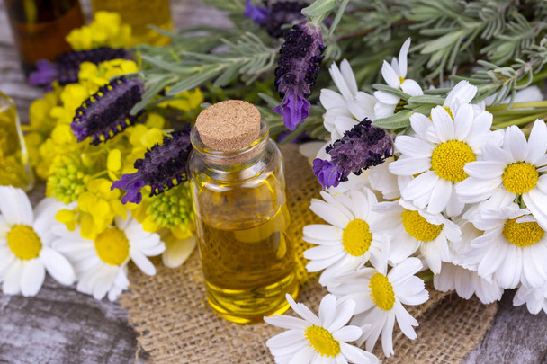 Mixed herbal oil. Essential oil various. Colorful flowers. - Photo, Image