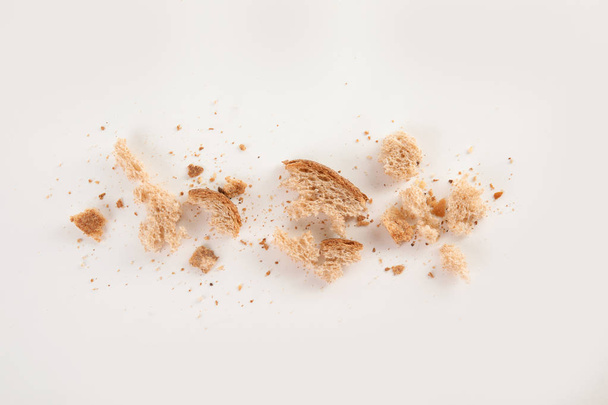 Scattered bread crumbs on white background, top view - Fotografie, Obrázek