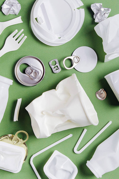 Plastic waste collection on  green background. Concept of Recycling plastic and ecology. Flat lay, top view - 写真・画像