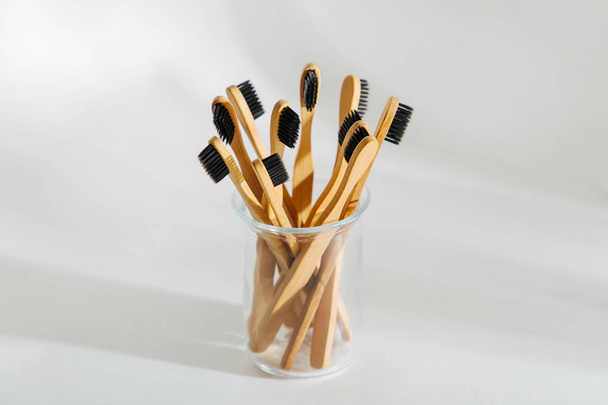 Eco friendly bamboo toothbrushes with black bristle, bathroom essentials on white background. Zero waste, plastic free concept.  - Фото, изображение