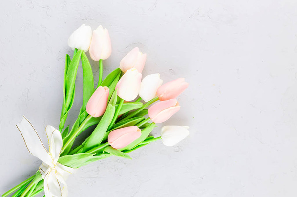 bouquet of light pink tulips on a gray concrete background - Zdjęcie, obraz