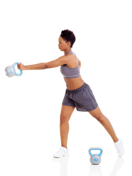 young adult afro american woman doing swing exercise with kettle - Photo, Image