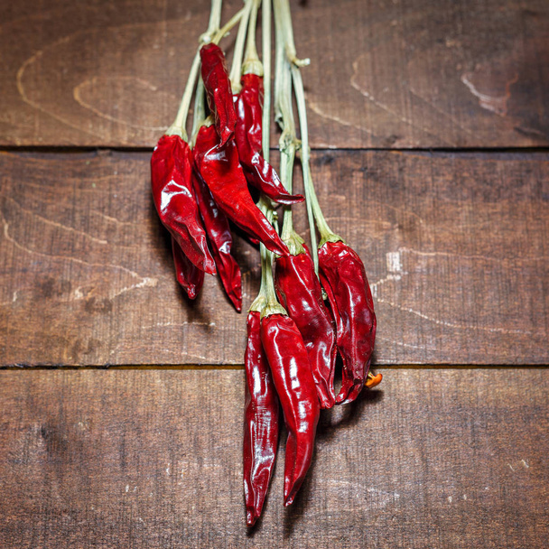 Red hot chili peppers on a wooden background - Photo, Image
