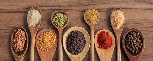 Spices and herbs. Colorful spices on wooden table, banner - Photo, Image