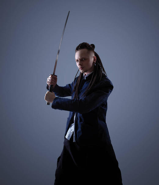 Young man holding a samurai sword. Glamour photo. - Φωτογραφία, εικόνα
