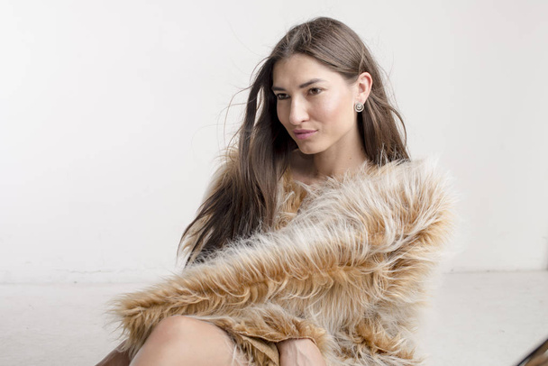 Beautiful model woman girl brunette in a fur coat - Photo, Image