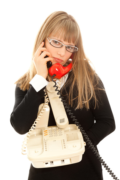 Displeasured woman with telephones - Photo, Image