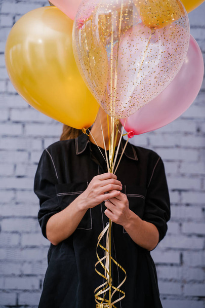 young woman holding colorful balloons, birthday concept  - Zdjęcie, obraz
