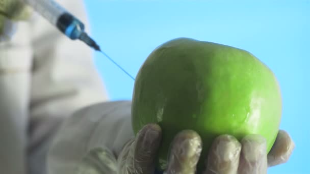 Scientist Injecting Apple with Chemical Solution for Experiment - Footage, Video