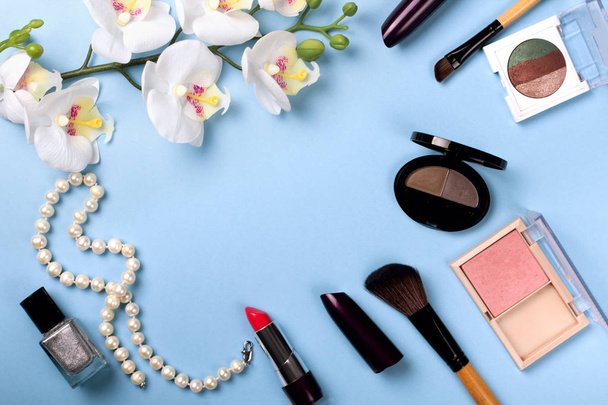 Set of cosmetics on color background with flowers. - Photo, Image