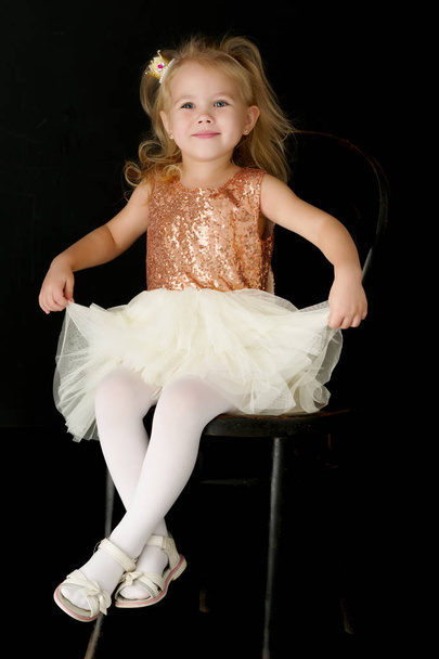 Little girl on a black background - Фото, изображение