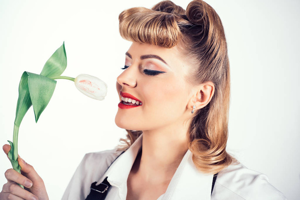 Spring woman concept. Girl and flower. Woman with a tulip. Aromas of nature. Cosmetics and perfume. Beautiful happy girl close up. - Photo, Image