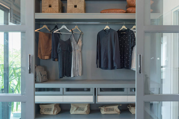 modern closet with clothes hanging - Фото, зображення