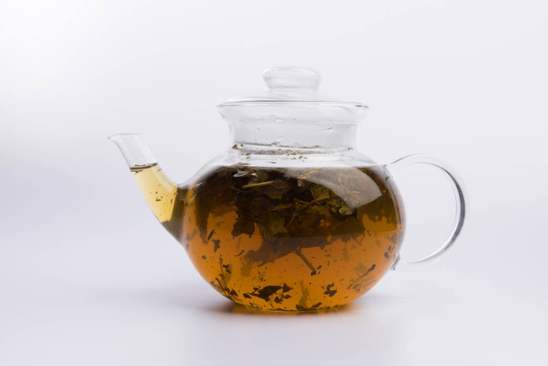 Teapot with tea isolated on white background - Fotó, kép