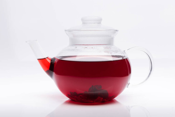 Glass teapot with hibiscus tea isolated on white background - Foto, Imagen