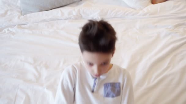 Little Boy Playing, Falls Asleep on Bed Before Bedtime - Кадри, відео