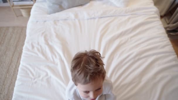 Little Boy Playing, Falls Asleep on Bed Before Bedtime. - Filmati, video