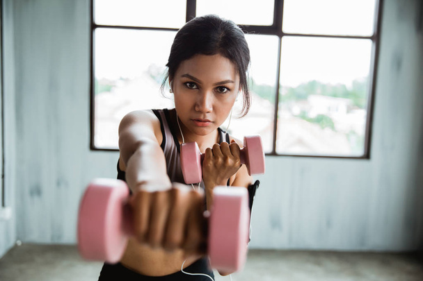 sporty woman with dumbbell doing weight exercise - Photo, Image