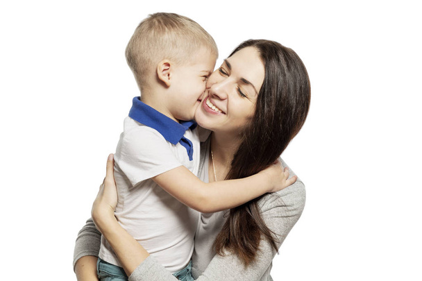 Cute little boy laughs and hugs with mom, isolated on white background - Fotó, kép