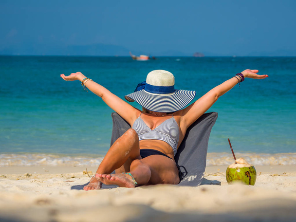 Woman enjoying her holidays on a transat at the tropical beach  - Fotografie, Obrázek