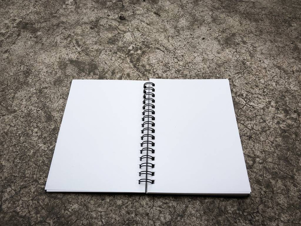 Top view of closed black cover notebook on the floor - Photo, Image