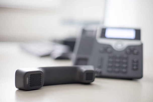 Classical black telephone in the office, customer support  - Фото, изображение