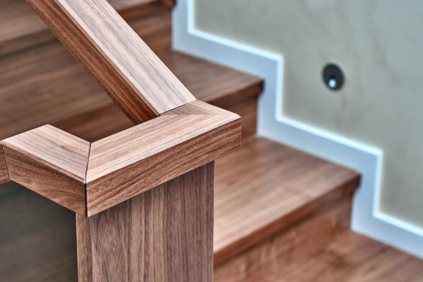 Part of wooden steps with glass railings. Walnut staircase - Foto, Bild