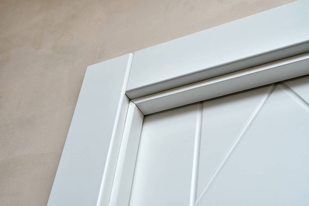 Contemporary white door with a pattern on the door leaf. Close-up - Photo, image