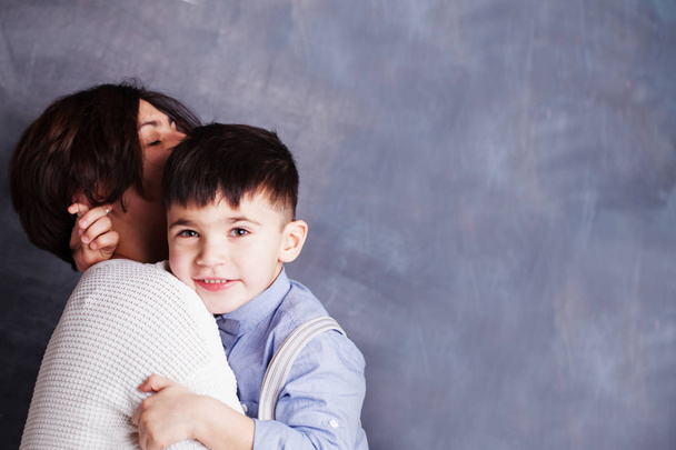 glückliche Mutter und Sohn umarmen sich auf Kreidetafel Hintergrund  - Foto, Bild